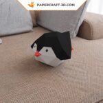 Papercraft of baby penguin sliding in 3D origami
