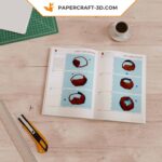 Papercraft of a hand emerging from the ground in 3D origami