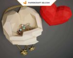 Papercraft hands holding a heart in origami