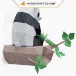 Papercraft panda sitting on bamboo in 3D origami
