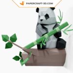 Papercraft panda sitting on bamboo in 3D origami