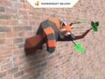 Papercraft panda rouge endormi sur une branche en origami 3D