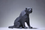 Papercraft black panther sitting in 3D origami