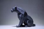 Papercraft black panther sitting in 3D origami