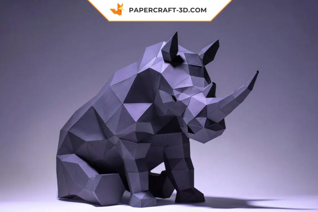 Papercraft de rinoceronte sentado en origami 3D