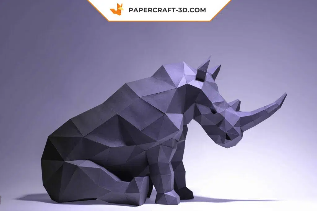 Papercraft de rinoceronte sentado en origami 3D