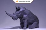 Papercraft di rinoceronte seduto in origami 3D