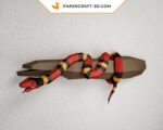 Papercraft of scarlet royal snake on branch