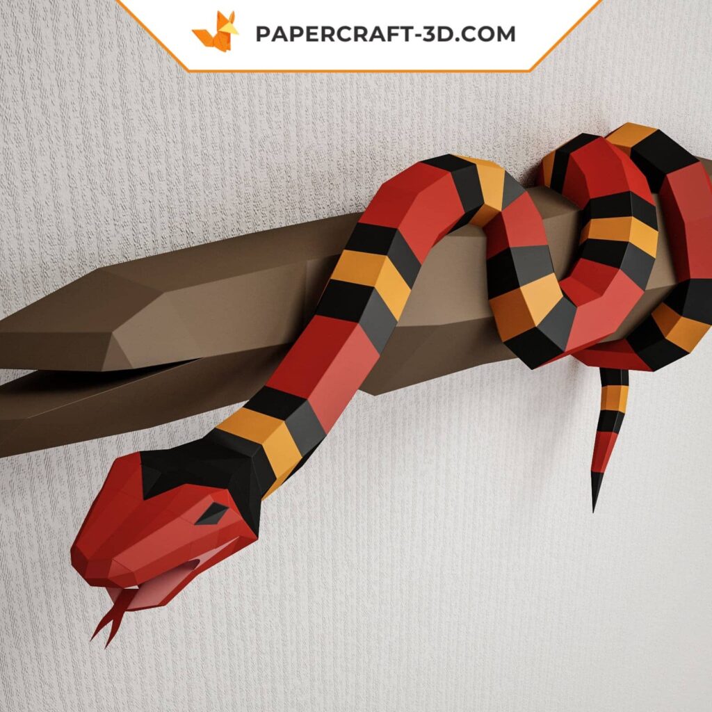 Papercraft of scarlet royal snake on branch