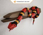 Papercraft of scarlet royal snake on branch