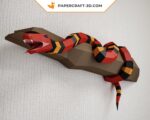 Papercraft of scarlet royal snake on branch