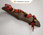 Papercraft of scarlet royal snake on branch
