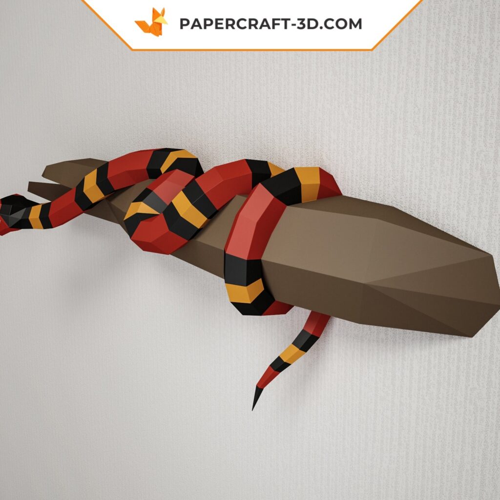 Papercraft of scarlet royal snake on branch