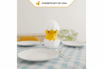 Papercraft poussin dans un œuf en origami 3D