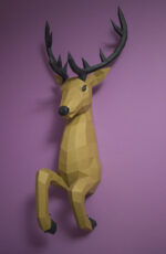 Papercraft deer emerging from wall in 3D origami