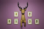 Papercraft deer emerging from wall in 3D origami