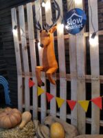 Papercraft deer emerging from wall in 3D origami