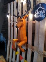 Papercraft deer emerging from wall in 3D origami