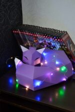 Papercraft fox on rock in 3D origami