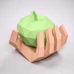 Papercraft hand holding 3D origami apple