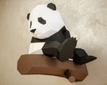 Papercraft panda on branch in 3D origami