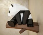 Papercraft panda on branch in 3D origami