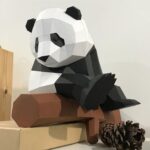 Papercraft panda on branch in 3D origami
