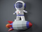 Papercraft astronaut on rocket in 3D origami