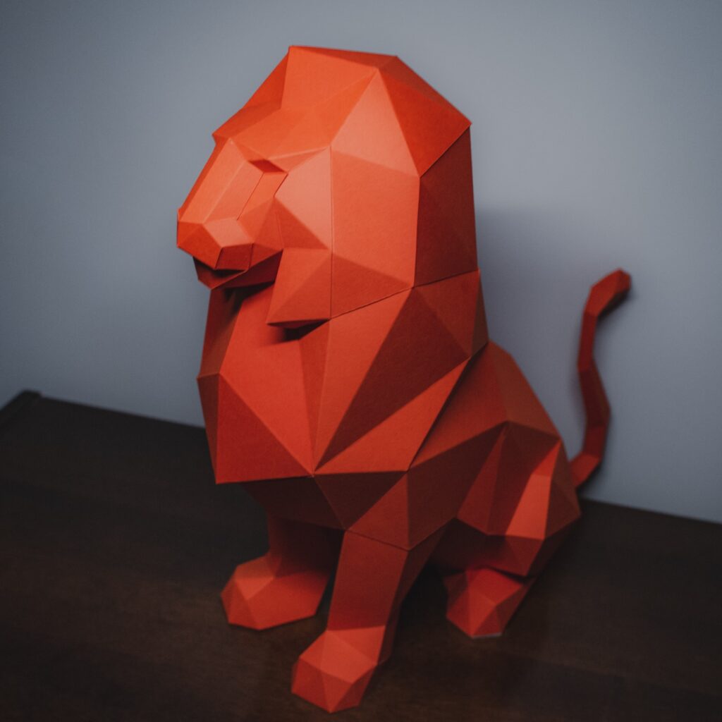 Papercraft of sitting lion in 3D origami