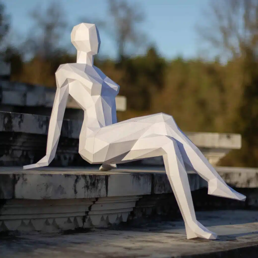 Papercraft of a seated woman in 3D origami Papercraft of a seated woman in 3D origami