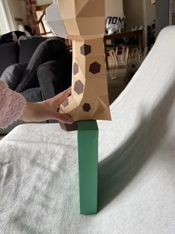 Girafe tachetée et cadre vert en cours d’assemblage
