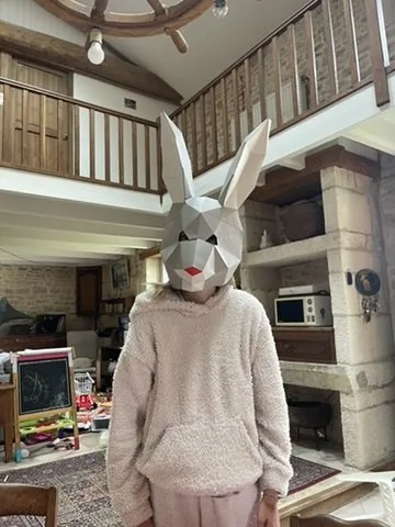 Masque de lapin blanc à nez rouge porté par une personne